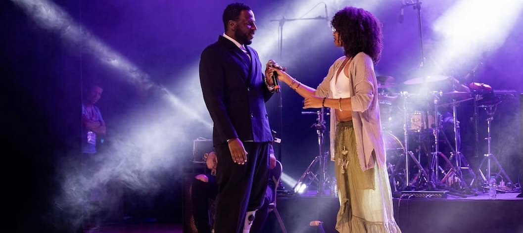 Lyssa performing a duet with Dino d'Santiago on stage at the Atlantic Music Expo